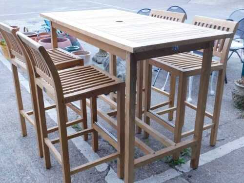 A Lifestyle Teak slatted high rectangular exterior bar table, with space for parasol, and four...