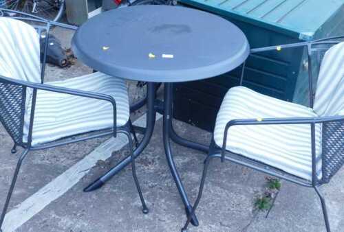 A patio set comprising circular table and two chairs.