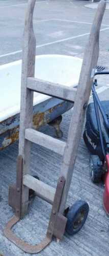 A wooden slatted sack barrow, with iron mounts.