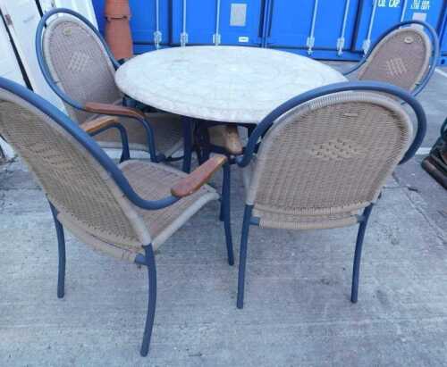 A Hartman Prestige patio suite, comprising circular table and four chairs, and four cushions.