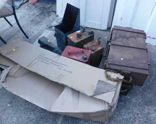 Various collectable vintage petrol cans, wooden ammunition crates, a galvanised firebox marked...