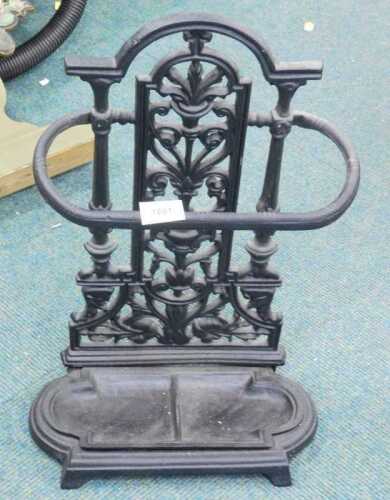 A 20thC iron umbrella stand, with lower compartment and pierced floral back, in black, 56cm high.