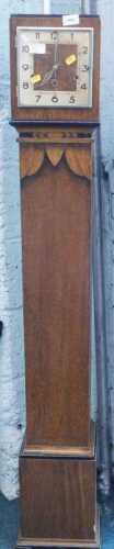 A 1920s oak chiming grandmother clock, with 19cm Arabic numerals, and three winding holes.