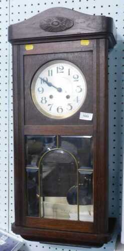 A mid 20thC oak cased wall clock, with 15cm diameter silvered Arabic dial, with eight day...