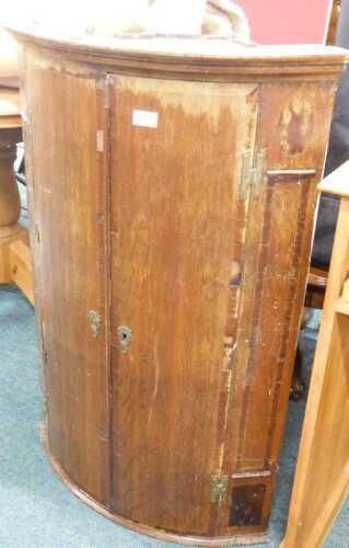 A 19thC oak barrel hanging corner cupboard. (AF)