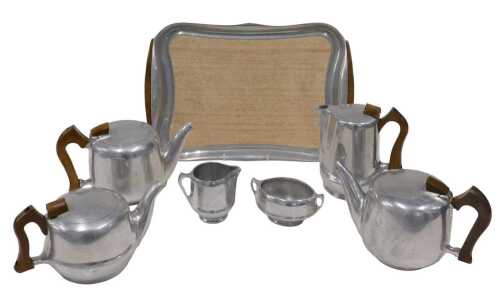 A Picquot ware part service, comprising tray, 39cm wide, three teapots, water jug, milk jug and...