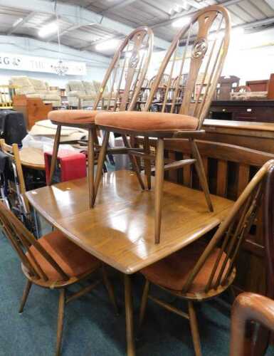 An Ercol dining room suite, comprising extending table of small proportion, and four chairs,...