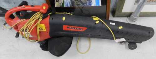 A Champion 102DBLWA electric leaf blower, with collection bag, in red and black trim.