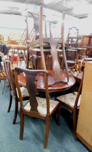 A late 20thC Italian dining table, of circular form, with printed leaf and scroll border, and...