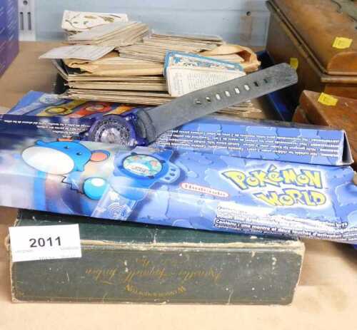 A Nintendo Pok&eacute;mon World Watch, together with cigarette cards, postcards, etc.