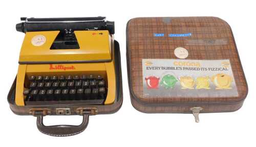 A child's Corona Lilliput typewriter, in orange and brown trim, 25cm wide, partially cased. (AF)