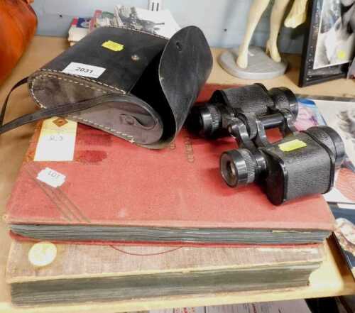Two postcard albums containing topographical interest, a pair of cased binoculars, photographs...