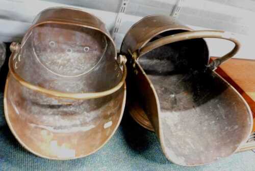 A copper coal scuttle, together with another similar example.
