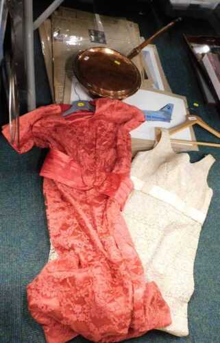 A lady's evening dress with raised with flowers in cream, together with a peach coloured evening...