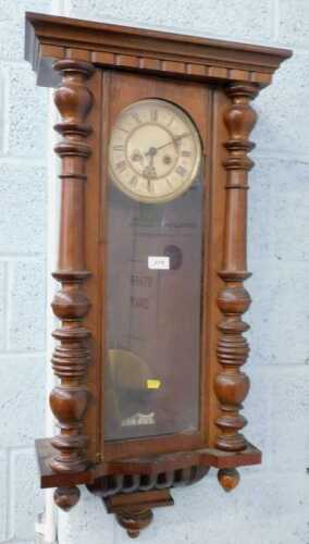 A late 19thC walnut cased Vienna wall clock, with 18cm diameter Roman numeric dial, in a three...