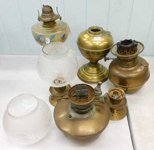 Various 20th century oil lamp parts, to include brass reservoirs, burners, glass chimneys, etc.
