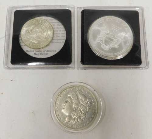 Three American coins, comprising a John F Kennedy silver half dollar, in presentation pack with...