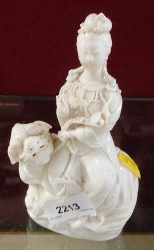 A 20thC Chinese blanc de chine hollow figure of a lady on dragon, unmarked, 18cm high.