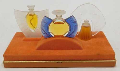 A perfume advertising stand, applied with three bottles of Lalique perfume, each in the Art Deco...