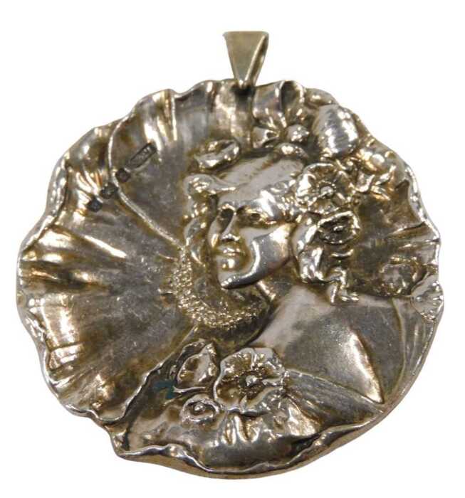 A Victorian silver pendant, moulded as a waterlily with embossed figure of female with flowing...