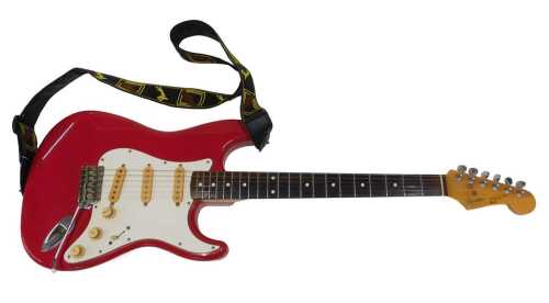 A Fender Squier Stratocaster electric guitar, in red and cream colourway, with six strings,...