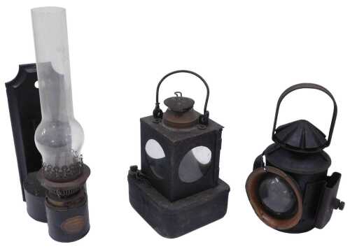 An early 20thC iron railway lantern, with fixed handle, shaped top, front circular plain glass...