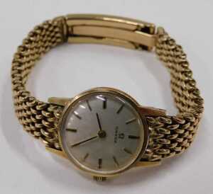 A 9ct gold Omega ladies wristwatch, with a silvered and baton watch face, on a full bar bracelet,... - 3