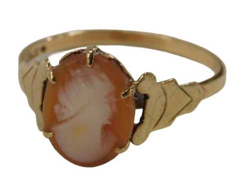A shell cameo dress ring, set with small cameo on V splayed shoulders, yellow metal stamped 9ct,...