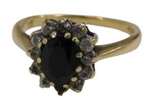 A 9ct gold floral cluster ring, set with central oval cut garnet, surrounded by imitation...