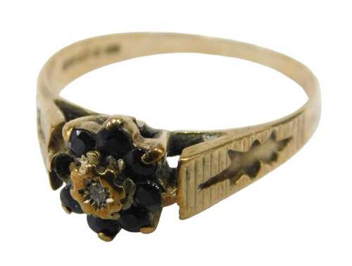 A 9ct gold and diamond floral cluster ring, the central illusion set diamond surrounded by seven...
