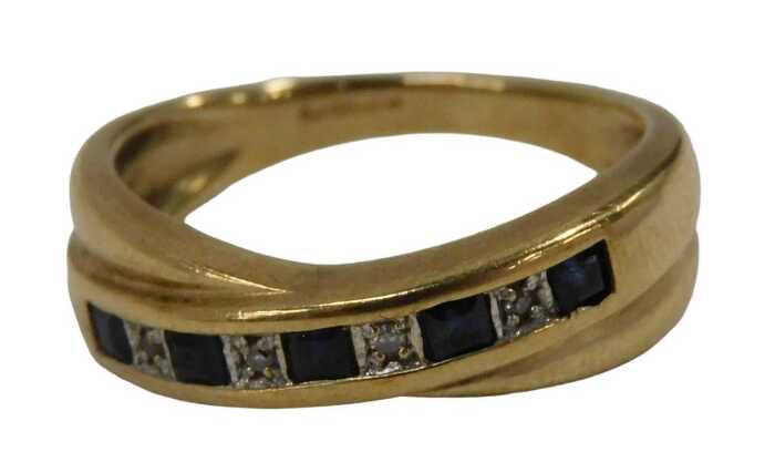 A 9ct gold half hoop dress ring, set with baguette cut sapphires and four round brilliant cut...