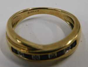 A 9ct gold half hoop dress ring, set with baguette cut sapphires and four round brilliant cut... - 2