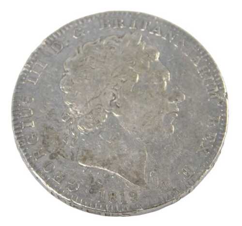 A George III silver crown coin 1819, in outer capsule.