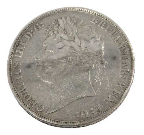A George IV silver crown coin 1821, in outer capsule.