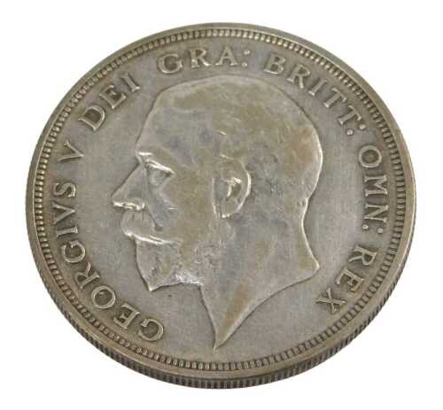 A George V silver crown coin 1929, in outer capsule.