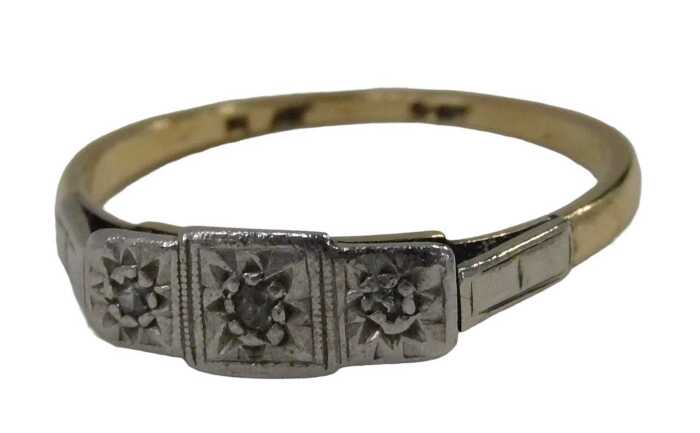 An Art Deco dress ring, the three sectional panel set with three tiny diamonds, on a yellow...