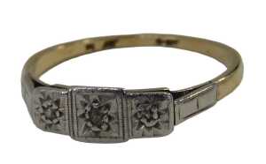 An Art Deco dress ring, the three sectional panel set with three tiny diamonds, on a yellow...