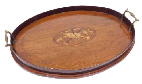 An Edwardian mahogany Sheraton Revival tea tray, of oval form with a gallery, centred with an...