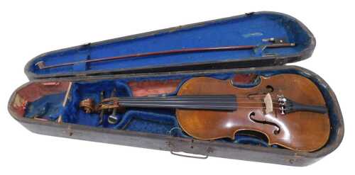 An early 20thC two piece violin, with 35cm back, scroll end and four strings, in fitted case,...