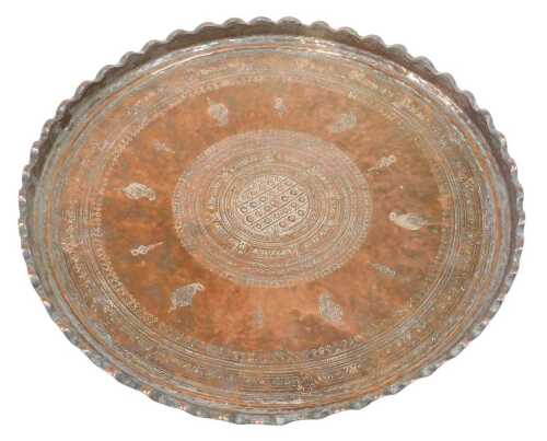 A 19thC Eastern copper tray, of flared circular form, profusely decorated with a central...