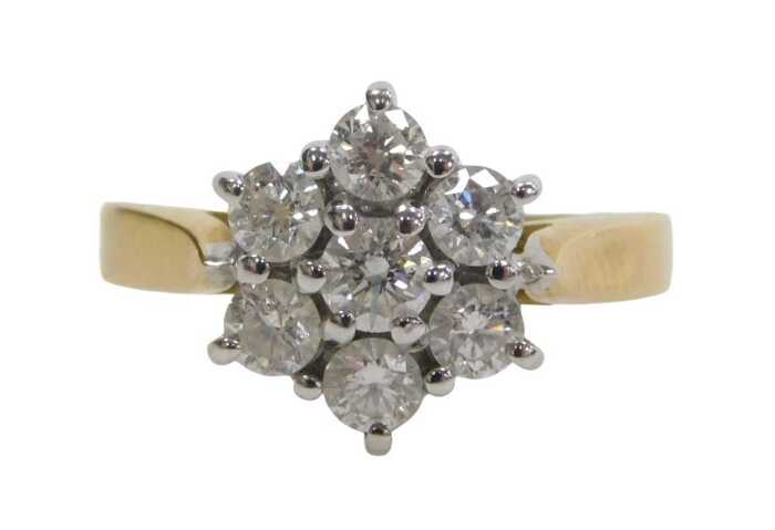 An 18ct gold diamond cluster ring, set with seven round brilliant cut diamonds, each...
