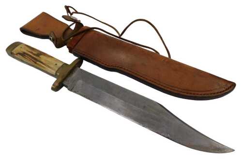 A 20thC large clip point bowie knife, with a shaped blade, stag antler handle and metal mounts,...