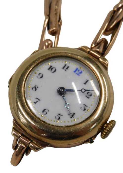 A mid-20thC wristwatch, the gold cased enamel watch head with a numbered border and blue hands,...