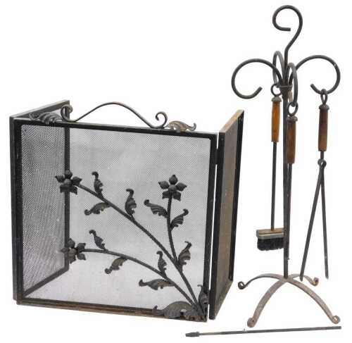 An early 20thC iron fireside companion set, comprising stand with hook top, 102cm high, brush...