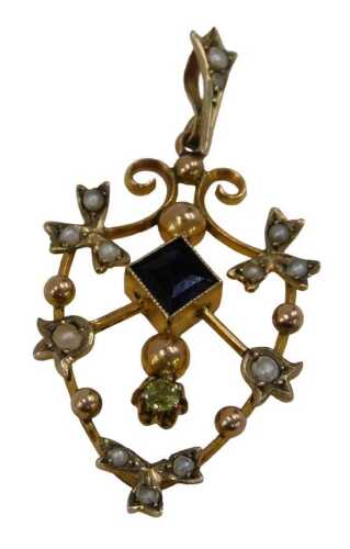 An Edwardian pendant, of shield shape, set with amethyst, peridot and seed pearls, yellow metal...