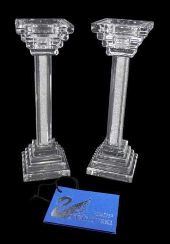 A pair of Swarovski crystal form candlesticks, of square form, on stepped bases, with inverted...