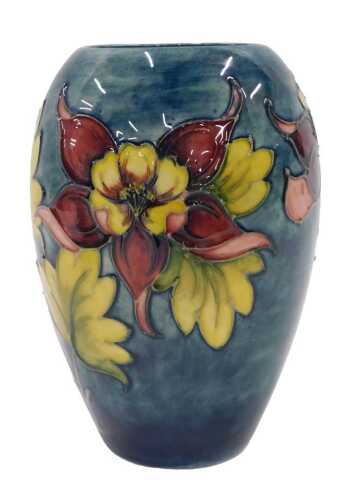A Moorcroft pottery Hibiscus pattern vase, on a green ground, 20cm high.