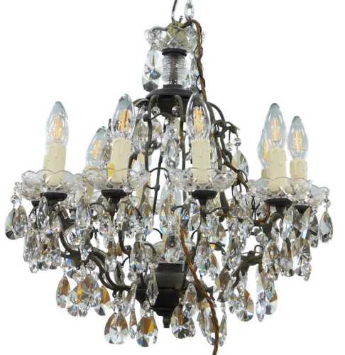 A highly elaborate 10 branch cut glass and crystal chandelier, centred with a compressed floral...
