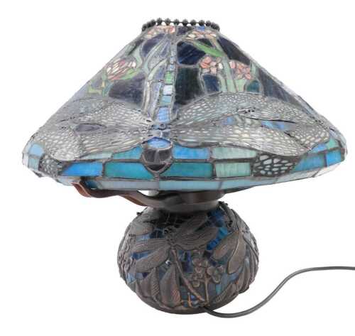 A 20thC Tiffany style table lamp, with squat shade, decorated with a repeat floral pattern on an...