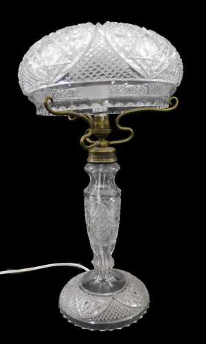 A 20thC crystal glass table lamp, the circular shade heavily hobnail cut, with a repeat...